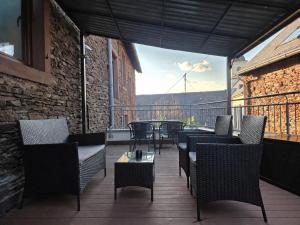 a balcony with chairs and a table with a view at VonMos Moselblick Apartments in Kinheim