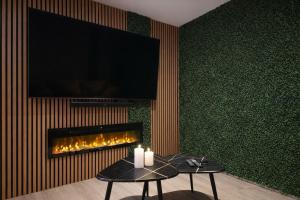a living room with a fireplace and a table with candles at VonMos Moselblick Apartments in Kinheim