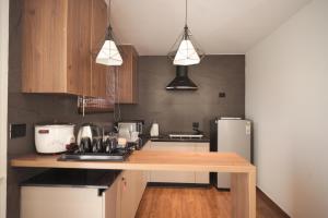 a kitchen with a wooden counter top and a refrigerator at Alpine Resort in Yelagiri