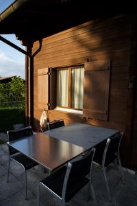 a table and chairs in front of a building at Chalet Enzian Wirzweli in Dallenwil
