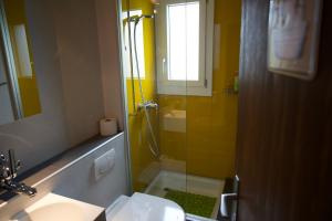 a bathroom with a shower and a sink and a mirror at Chalet Enzian Wirzweli in Dallenwil +14 photos