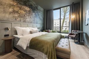 a bedroom with a bed and a large window at Home Hotel Gabelshus in Oslo +56 photos