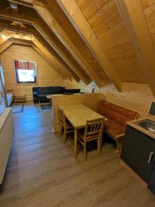 a dining room with a table and a bench at Studio DG für 1 Person in Kelheim