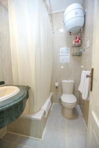 a bathroom with a sink and a toilet and a shower at Guardian Guest House in Cairo +48 photos