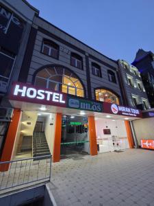 a building with a hospital sign in front of it at Miran Hostel 2 Vokzal in Andizhan