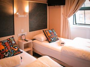 a hotel room with two beds and a window at Gardiner House Hostel in Dublin +134 photos