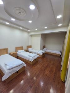 a hospital room with three beds and a ceiling at Miran Hostel 2 Vokzal in Andizhan +12 photos
