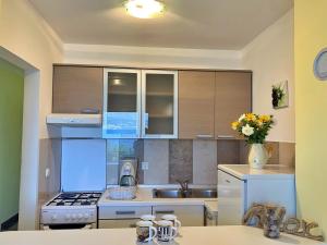 a kitchen with a sink and a stove top oven at Apartments Beach in Šilo +72 photos