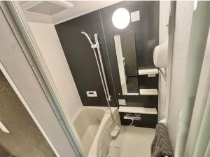 a small bathroom with a shower and a toilet at HoTTOSTAY旭 in Nishi-biwajima +12 photos