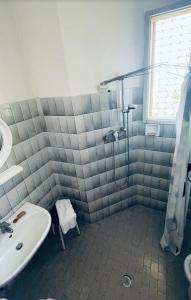 a bathroom with a shower and a sink and a tub at Hotel Villa Verde in San Mauro a Mare +15 photos