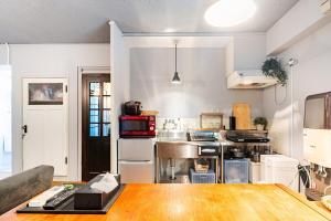 a large kitchen with a sink and a stove at 田 Den Kamakura Petと泊まれる ペット滞在費別途 in Kamakura
