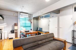 a living room with a couch and a table at 田 Den Kamakura Petと泊まれる ペット滞在費別途 in Kamakura