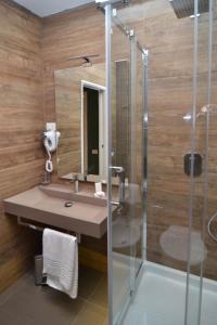 a bathroom with a sink and a shower at Bed In Centro in Naples