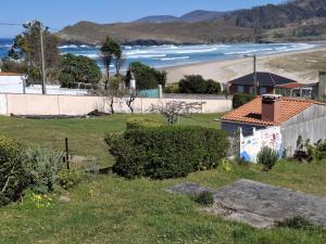 a house with a view of a beach and the ocean at Mar de Pantin in Valdoviño