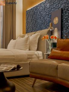 a living room with a bed and a couch at Cubicity Hoang Dieu in Ho Chi Minh City +43 photos