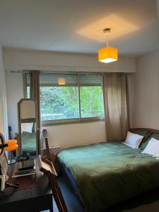 a bedroom with a bed and a mirror in it at Une terrasse sur Monaco logement 2 chambre in Beausoleil