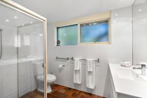 a bathroom with a toilet and a sink and a shower at Bungunyah Apartments in Croydon +116 photos