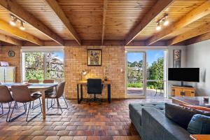 a living room with a couch and a table at Bungunyah Apartments in Croydon