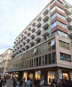 a large building with people walking in front of it at In Centro B&B in Naples