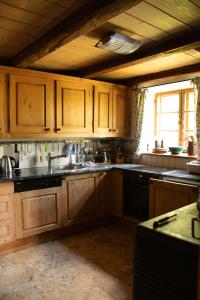 a kitchen with wooden cabinets and a sink at Bauernhaus auf dem Land in Hebertsfelden