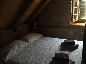 a bedroom with a bed in a attic with a window at Vila Lovrečina in Postira +13 photos
