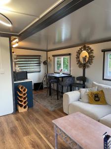 a living room with a couch and a table at Stunning birch tree Lodge in Otley