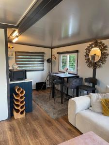 a living room with a couch and a table at Stunning birch tree Lodge in Otley