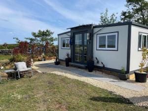 a tiny house parked in a garden at Stunning birch tree Lodge in Otley