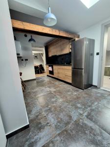a large kitchen with a stainless steel refrigerator at Apartament Mickiewicza 6 in Września