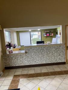 a lobby with a stone counter with a counter top at Super 8 by Wyndham Columbia City in Columbia City