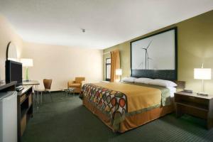 a hotel room with a large bed and a television at Super 8 by Wyndham Columbia City in Columbia City