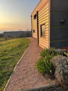 a house with a gravel path next to a building at Résidence du Champ Lamet in Pont-du-Château