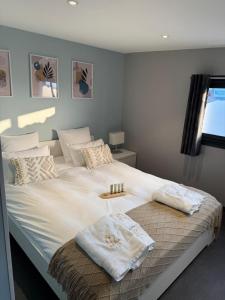 a bedroom with a large bed with two towels on it at Résidence du Champ Lamet in Pont-du-Château