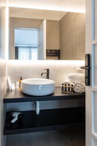 a bathroom with a sink and a large mirror at Seta Hotel in Bellagio +57 photos