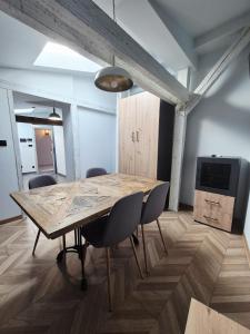 a dining room with a wooden table and chairs at Apartament Mickiewicza 6 in Września
