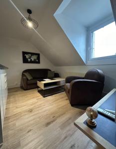 a living room with a couch and a table at Le Studio du Square : Châteaux-Beauval-Arrivée auto-Netflix in Romorantin