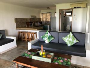 a living room with a couch and a table at Go Wild Beach Resort in Quebanhane