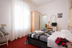 a bedroom with a bed with flowers on it at Villa Silvie Rose in Cesenatico