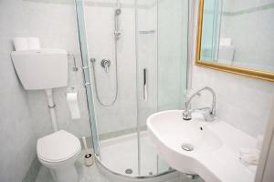 a bathroom with a shower and a toilet and a sink at Villa Silvie Rose in Cesenatico +37 photos