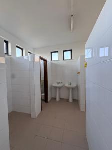 a bathroom with two sinks and two toilets at Lagartoca in Vilar de Amargo