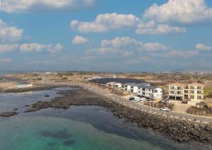 an aerial view of a beach with houses and the water at Jeju Bahama Pension in Jeju