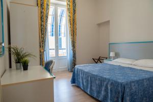 a hotel room with a bed and a window at Hotel Centrale in Pineto