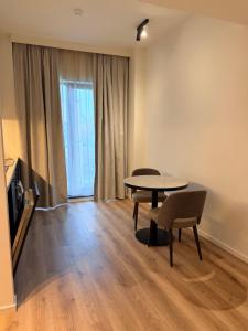 a dining room with a table and chairs and a window at Stay at Brussels in Brussels