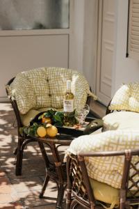 a table with a bottle of wine and a glass at Milto's Studios in Parga