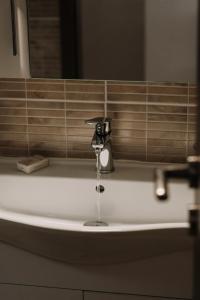 a sink with a faucet in a bathroom at Milto's Studios in Parga +50 photos