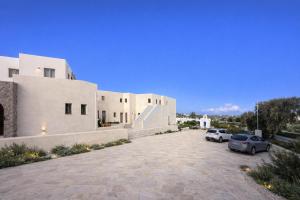a building with two cars parked in a parking lot at Kali Naousa in Naousa +12 photos