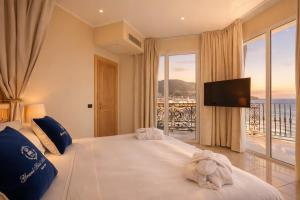 a bedroom with a large bed and a large window at LVG Hotel Collection - Grand Hotel Mediterranee in Alassio