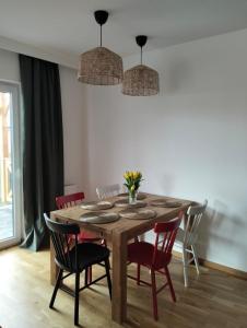 a dining room with a wooden table and chairs at Chata na Psiaku in Wrocław +11 photos