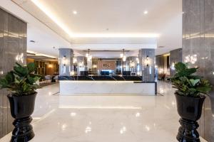 a lobby of a hotel with potted plants at Hotel Riu Palace Nautilus - Adults Only in Torremolinos +52 photos
