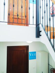 a door in a building with a sign on it at LA CASINA DE HUGO AZUL centro Luanco in Luanco